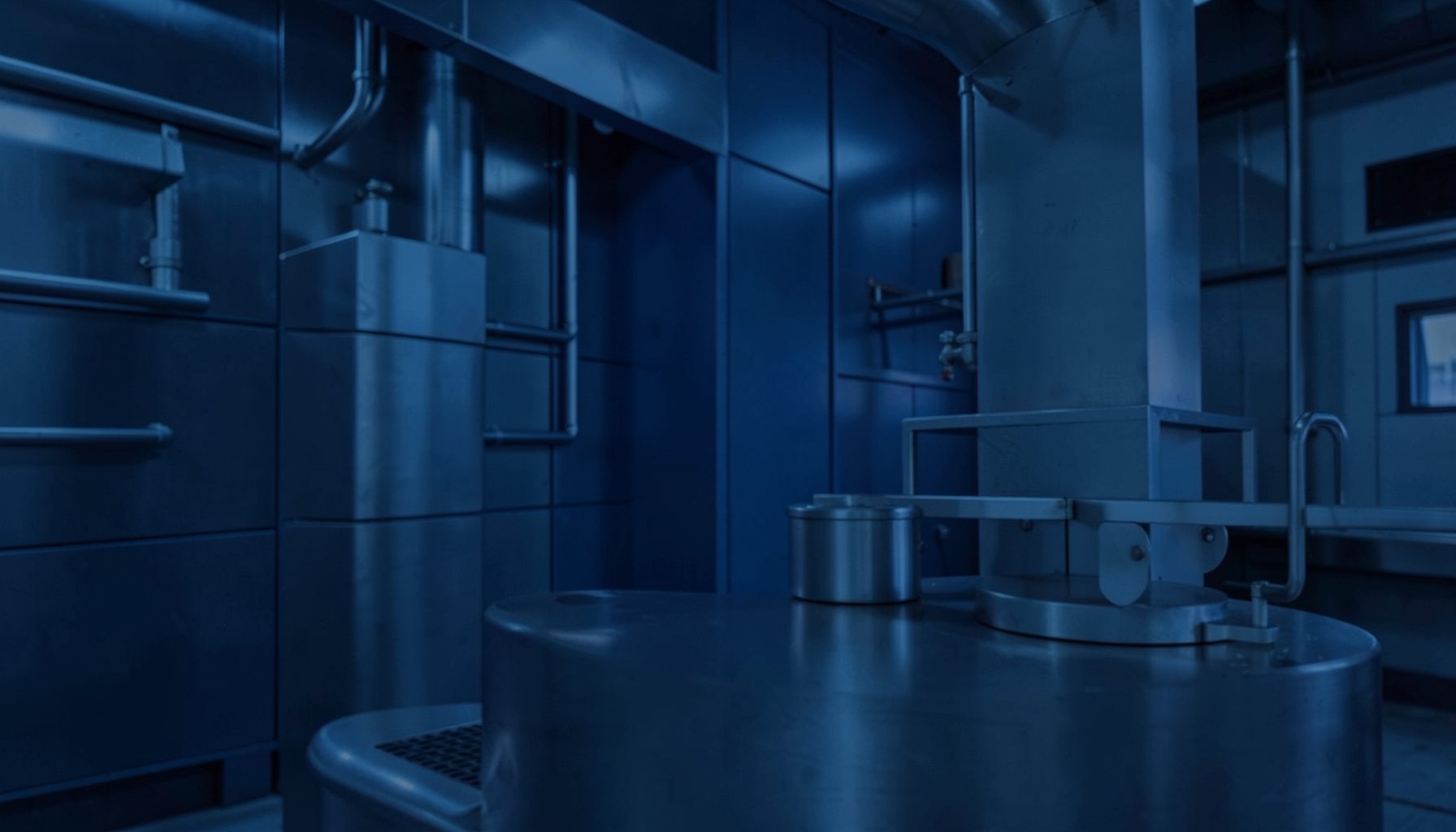 Abstract industrial backdrop with deep indigo and muted steel-blue tones, suggesting precision metal refining in a clean, modern setting