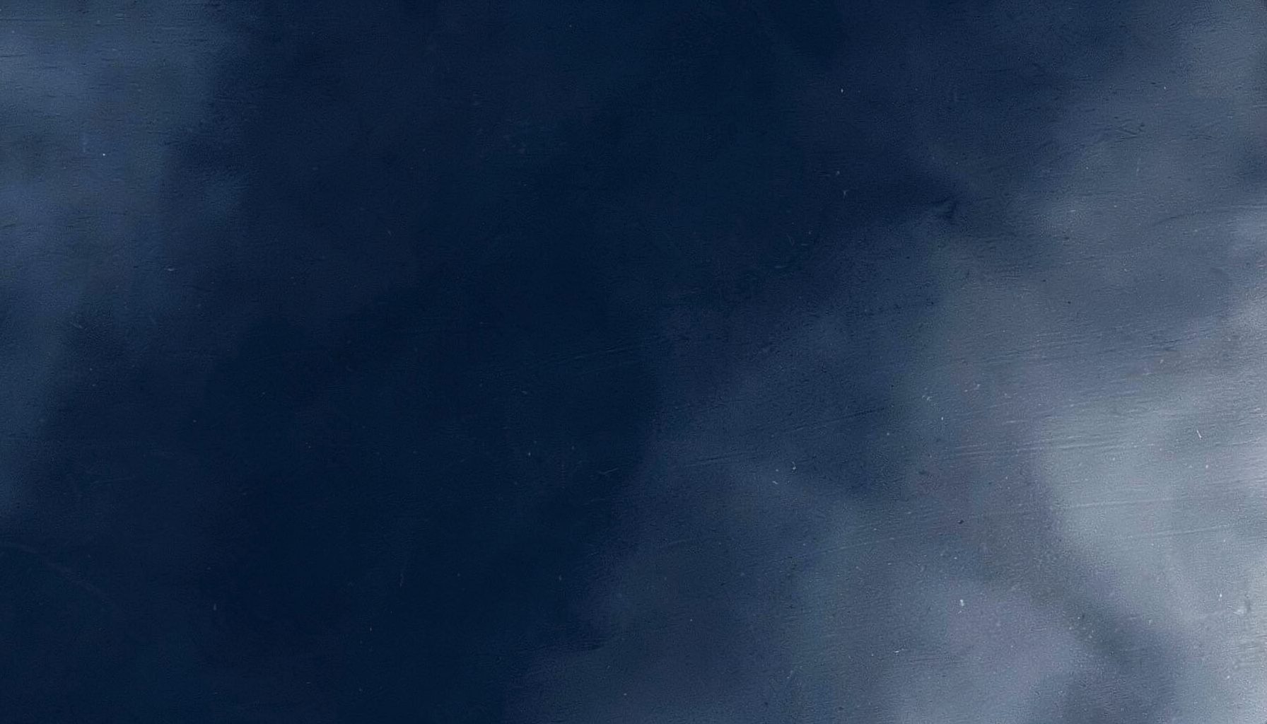 Abstract industrial texture in deep navy and muted silver tones, suggesting precision engineering and clean metallurgical processing